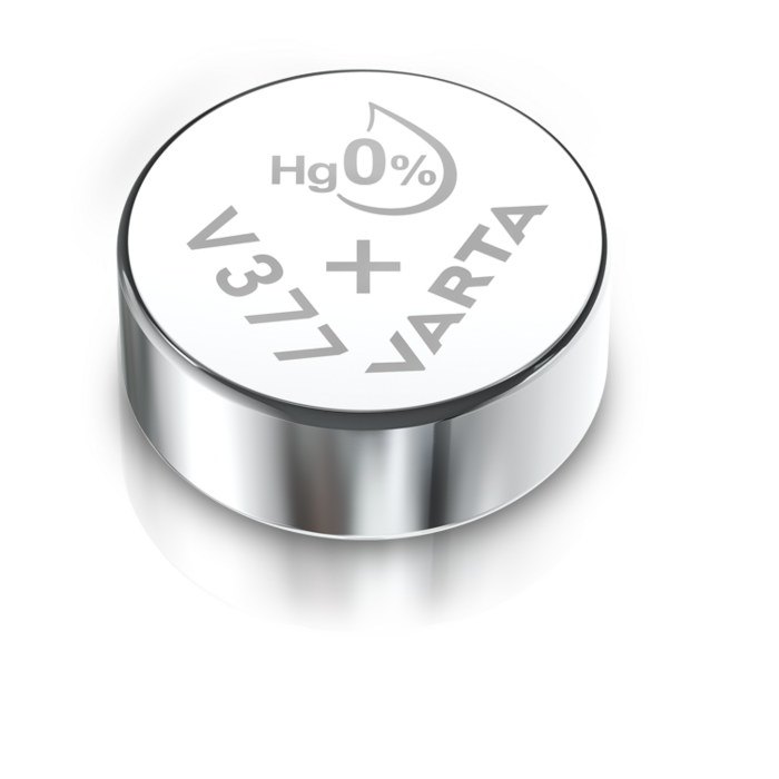 Silver Varta V377 button cell battery with Hg 0% mercury-free label on top, shown on reflective white surface
