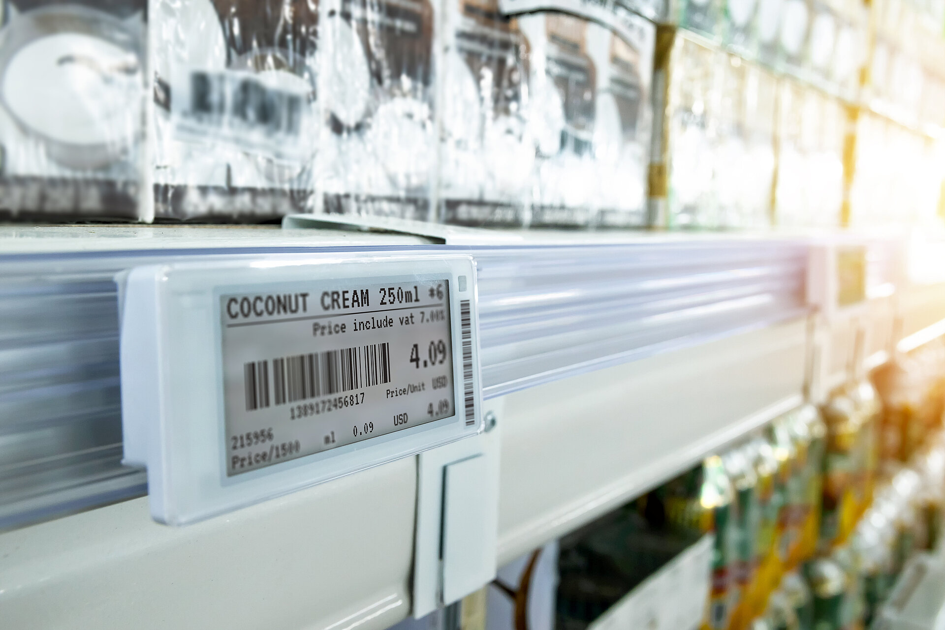 Electronic shelf label displaying Coconut Cream 250ml priced at 4.09 USD with barcode on a supermarket shelf edge