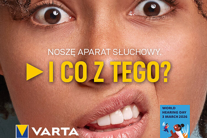 Zbliżenie twarzy kobiety, napis "Noszę aparat słuchowy. I co z tego?", logo Varta, Światowy Dzień Słuchu 2026