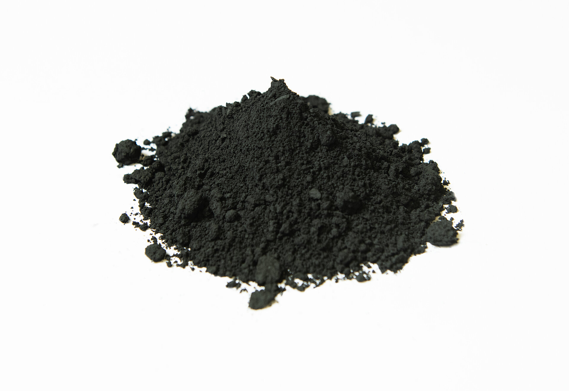Pile of fine black powder on a white background