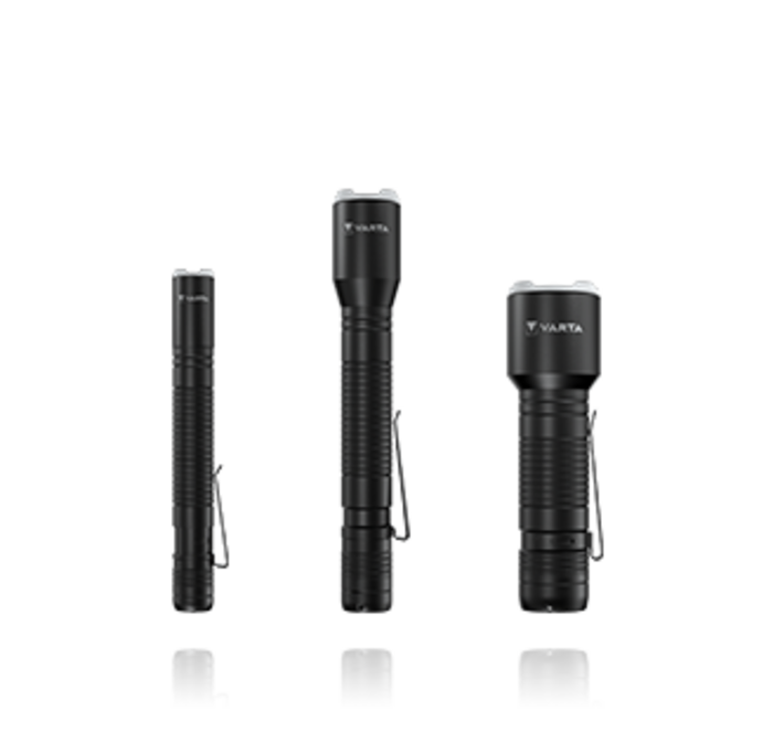 Three black Varta flashlights of varying sizes standing upright side by side against a white background
