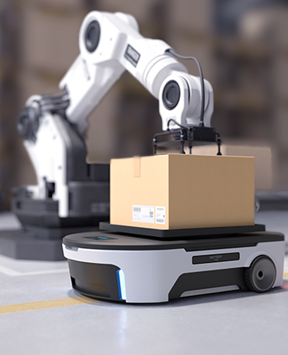 Robotic arm placing a cardboard box onto an autonomous mobile robot in a warehouse setting