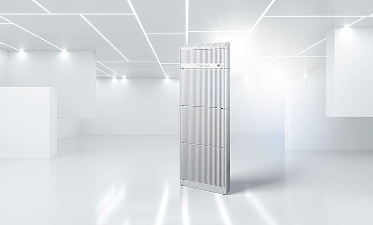 Tall silver modular energy storage unit standing in a bright white modern showroom with geometric ceiling lights