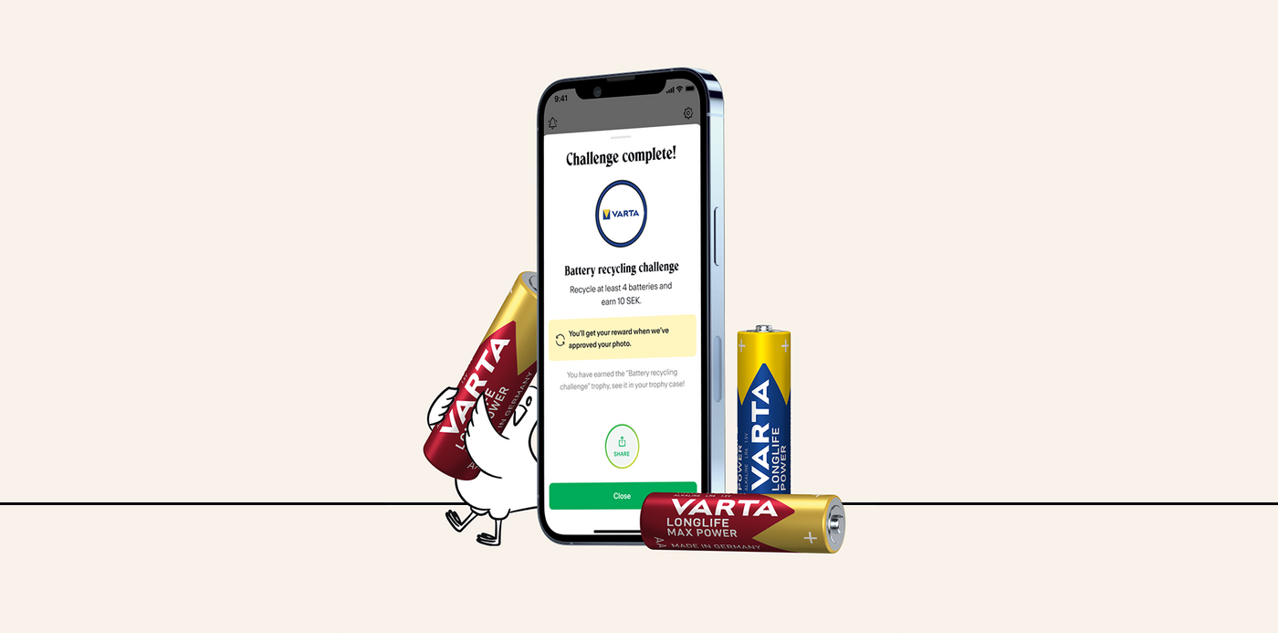 Smartphone showing Varta battery recycling challenge complete screen, with two Varta Longlife batteries and a cartoon chicken